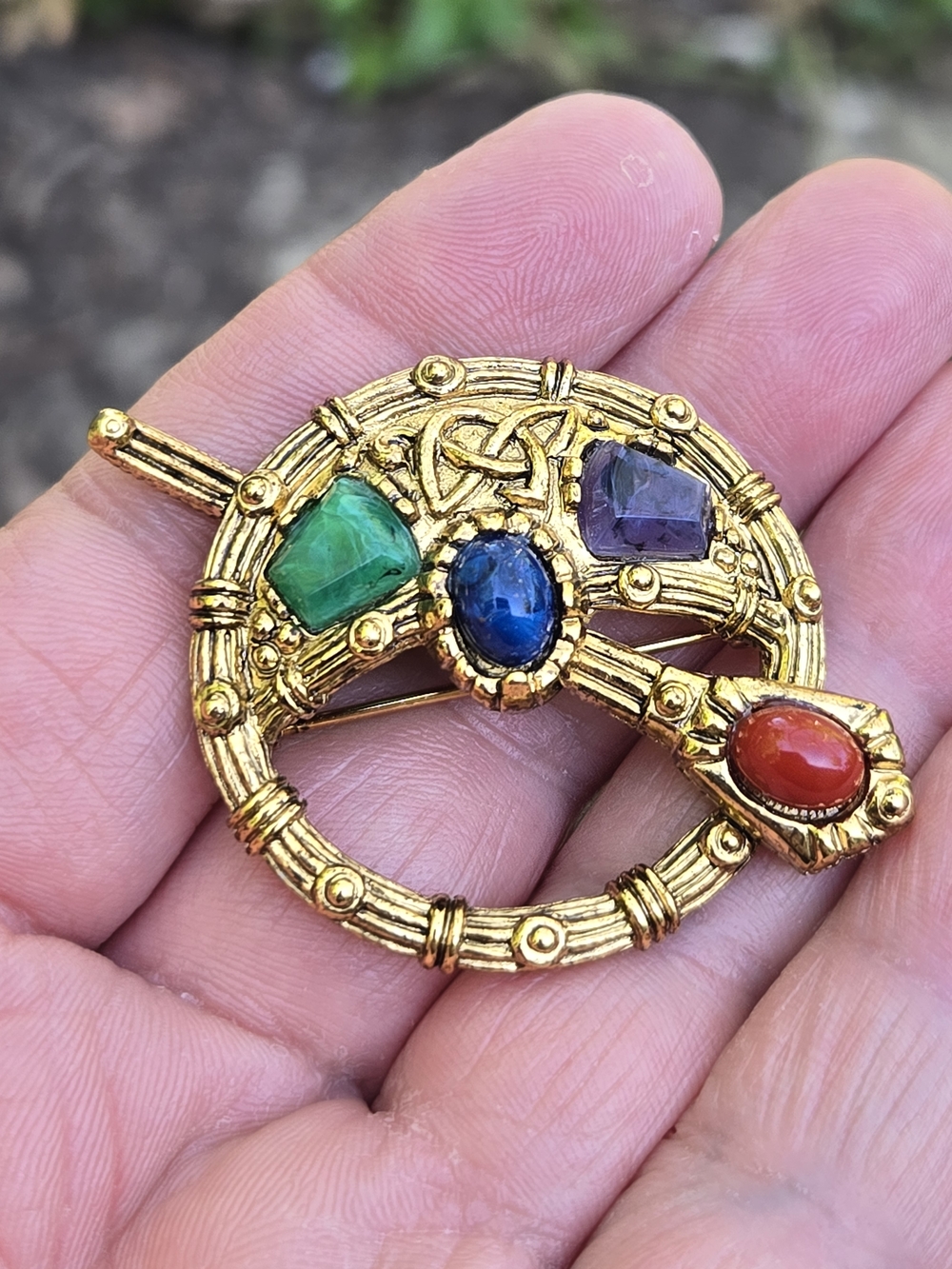 Vtg mostly circular brooch, multicolored embellishments.